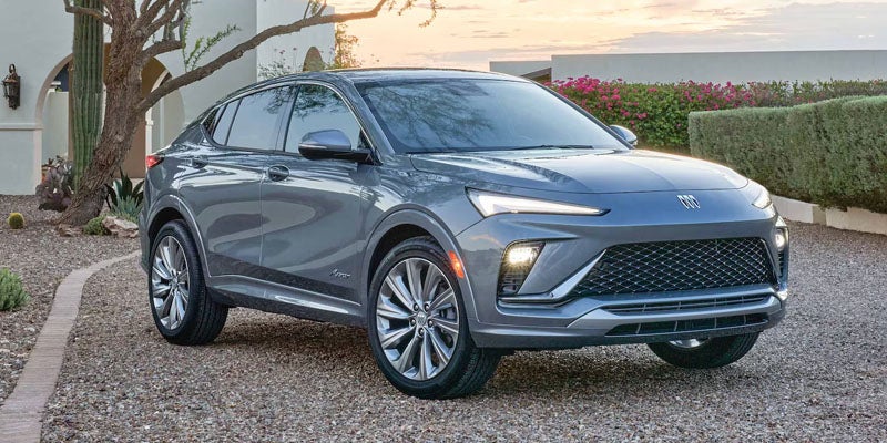 A Buick Envista parked on a gravel driveway, showcasing its sleek design and modern features.